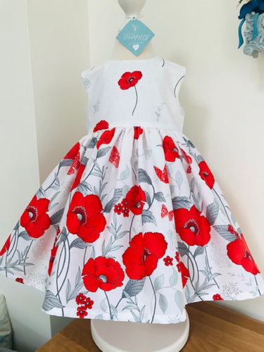 The Wishfairy Bunty Baby Dress (Large Red Poppies Border On White)