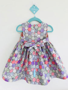 The Wishfairy Bunty Baby Dress (Bee Hexagons Natural)